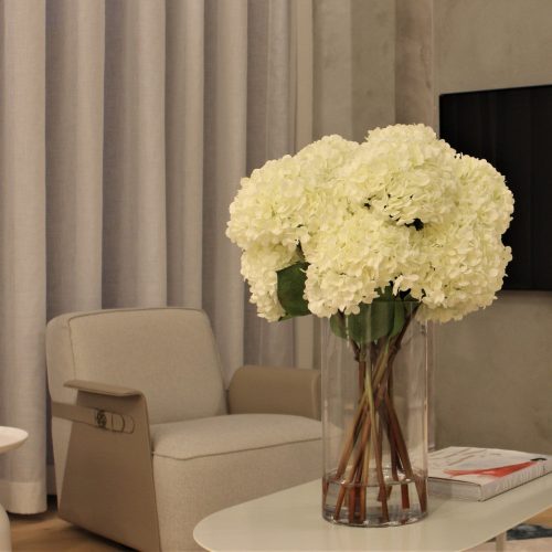 White Hydrangea Bouquet in clear tall glass cylinder vase